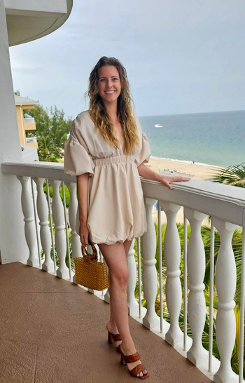 reviewer holding brown beaded bag