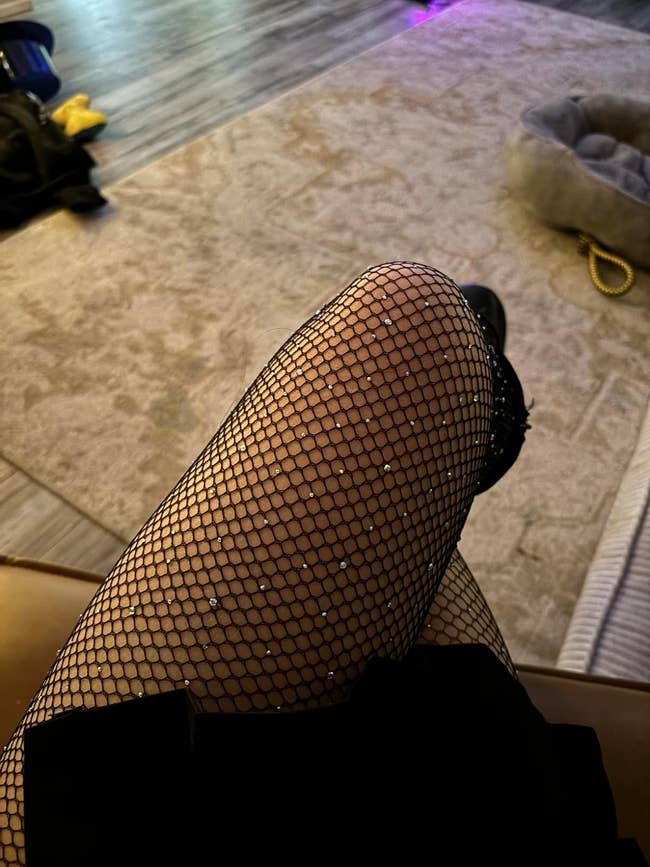 Person wearing fishnet stockings and combat boots