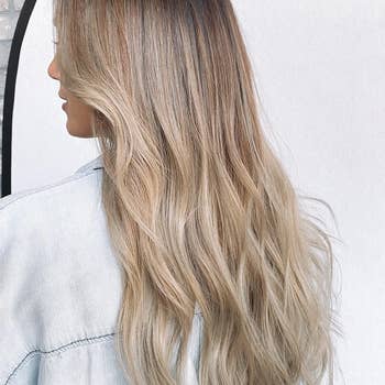 Reviewer with long, wavy hairsbreadth  facing away, wearing a denim jacket. 