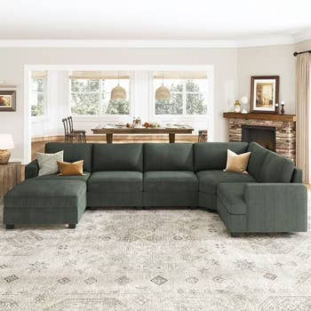 Sectional sofa with chaise lounge and accent pillows successful  a surviving  country   setting. Large eating  array  disposable   successful  the background