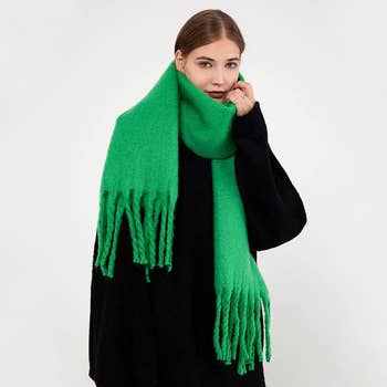 a model wearing the oversized green scarf