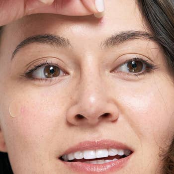 A model applying the patch over a pimple