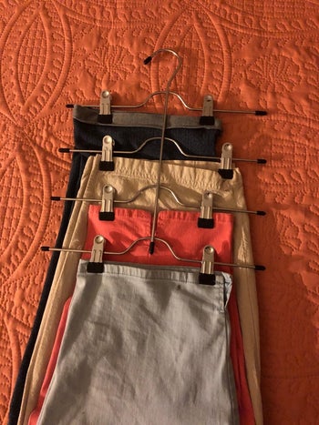 the same reviewer showing the front view of the hanger with four skirts on it