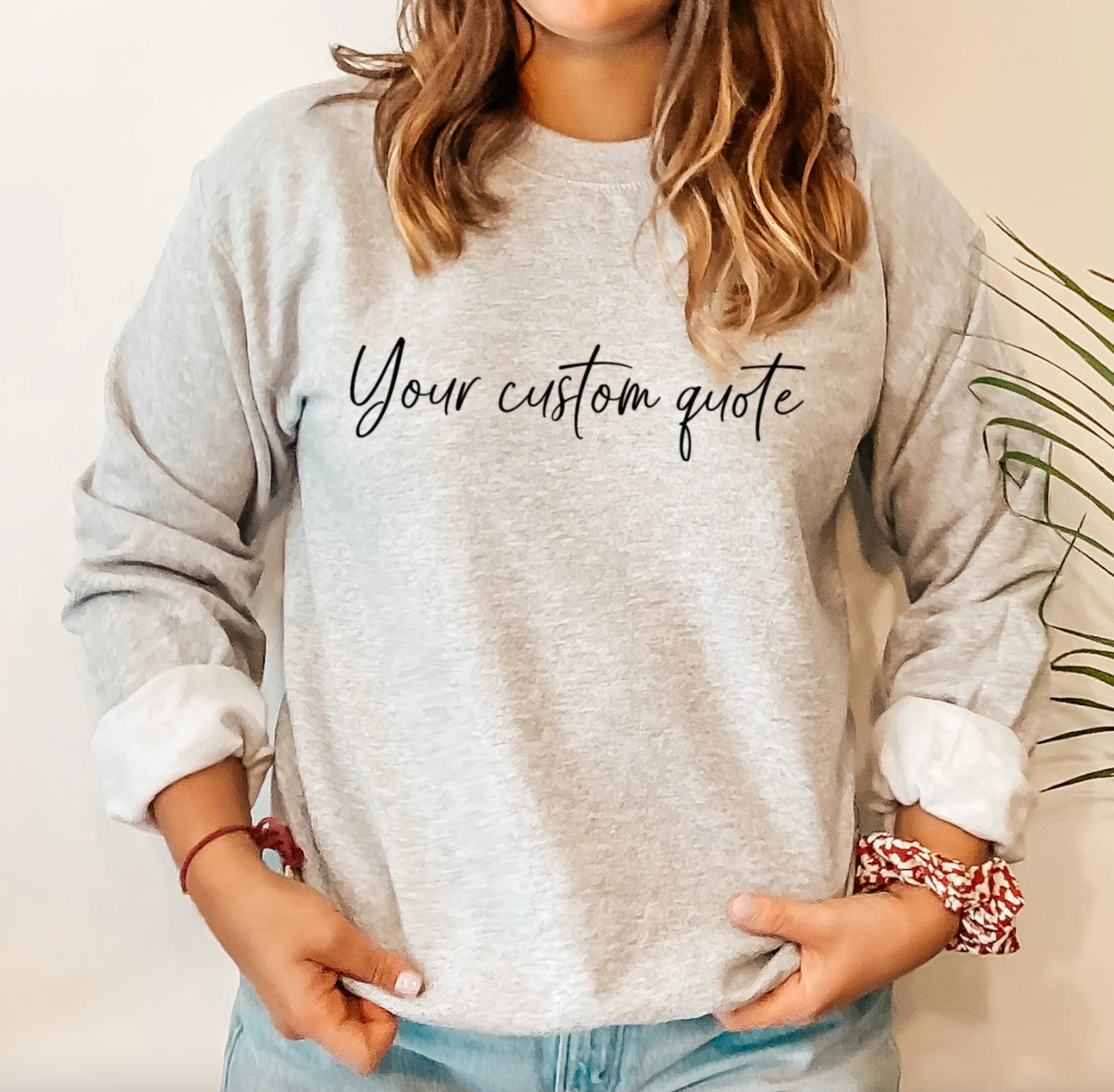 model wearing gray sweatshirt that can be personalized with custom text