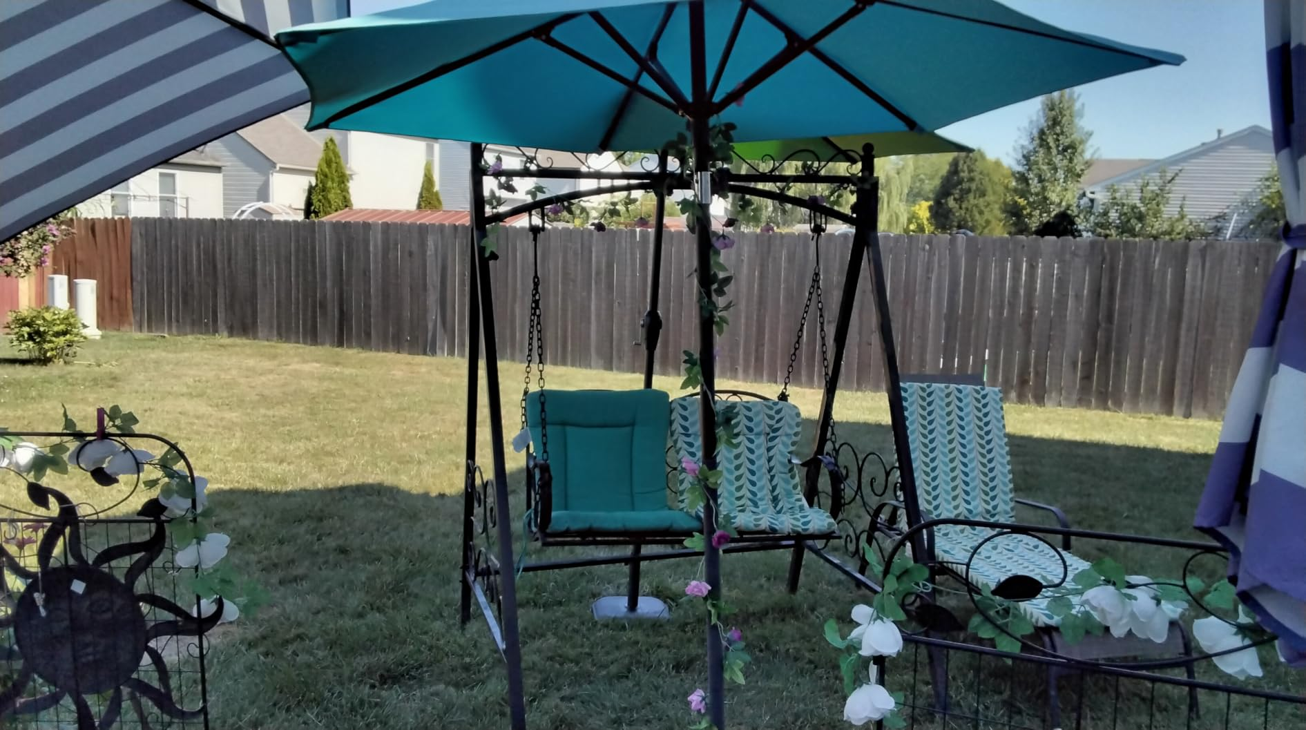 Patio acceptable   featuring a plaything  nether  an umbrella, with decorative floral accents, suitable for outdoor relaxation and entertainment