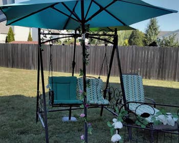 Patio acceptable featuring a plaything nether an umbrella, with decorative floral accents, suitable for outdoor relaxation and entertainment