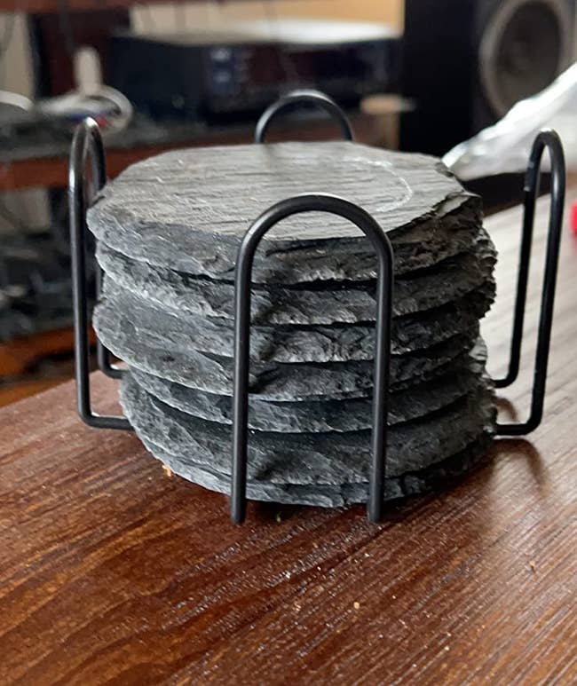 reviewer image of six slate black coasters in holder