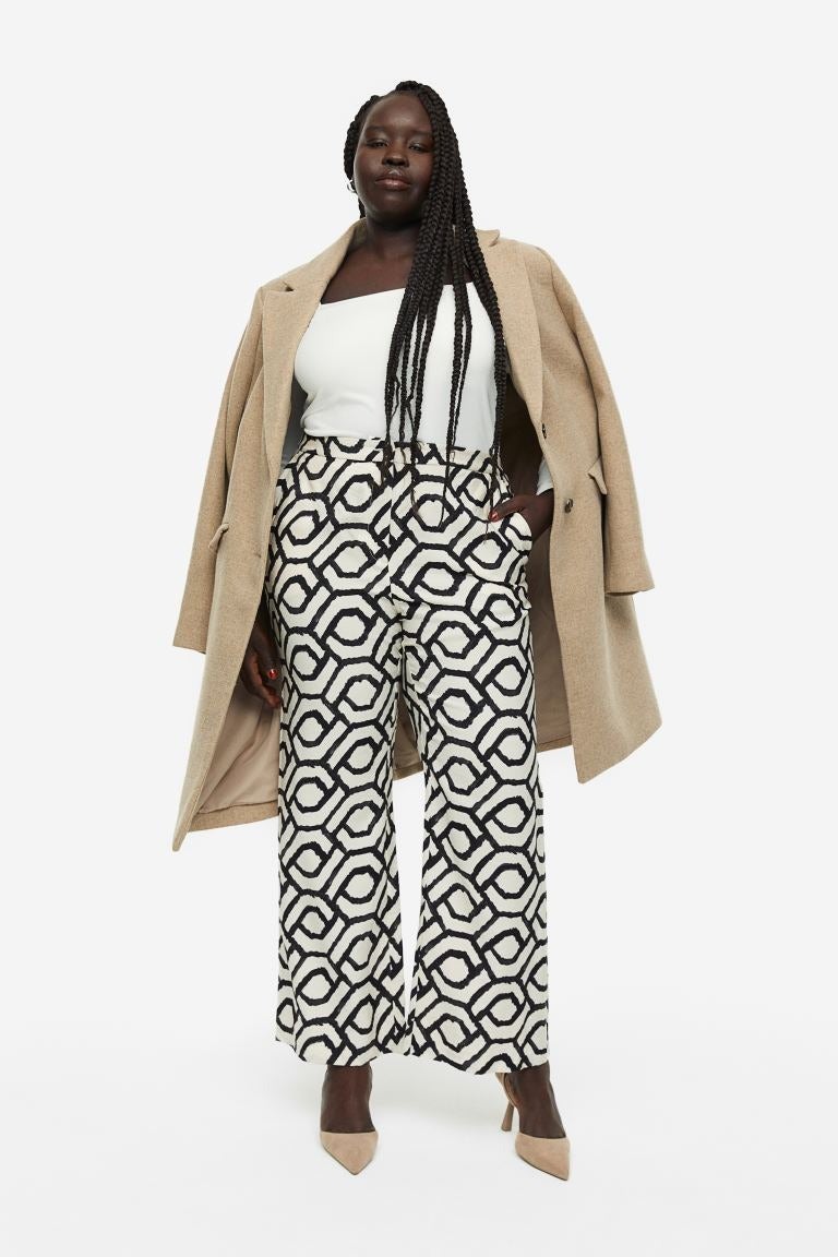 model wearing the black and white printed flared pants