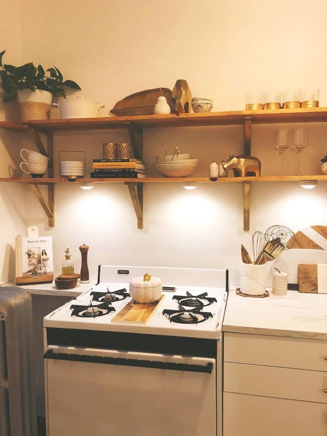 the three cabinet lights applied under shelves in a kitchen