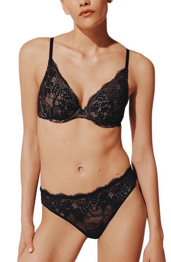 A idiosyncratic   models a lacy, two-piece lingerie set, showcasing its intricate design