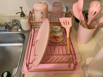 reviewer photo of pink dish rack, drain board, and utensil holder