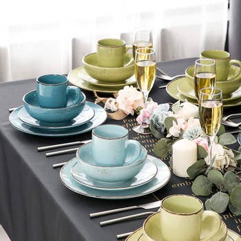 the blue and green dinnerware on a set table