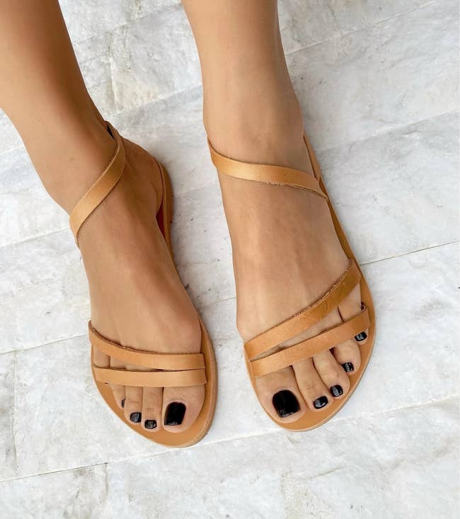 model's feet wearing the tan sandals