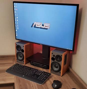 Reviewer image of both of the wooden speakers next to a computer