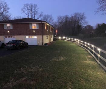many of the lit lights on the side of a reviewer's house and fence
