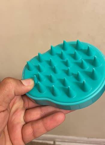 Reviewer holding the massager to show the textured spikes