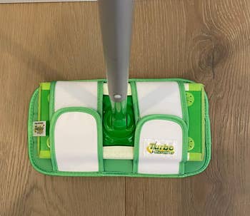 Flat mop with microfiber pads connected  a wood   floor, featuring a 