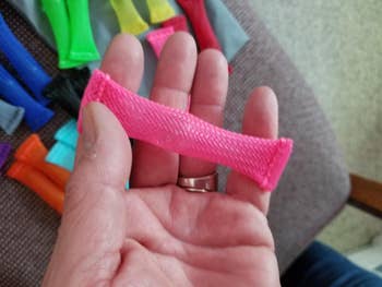 Reviewer holding the pink mesh toy