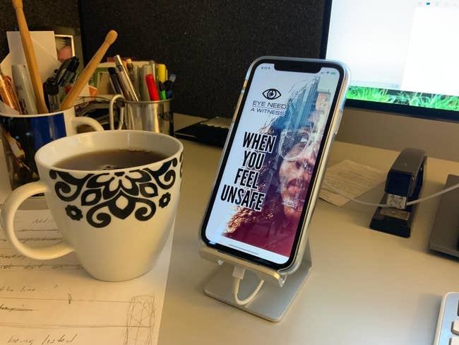 reviewer image of a phone resting on a phone stand on a desk
