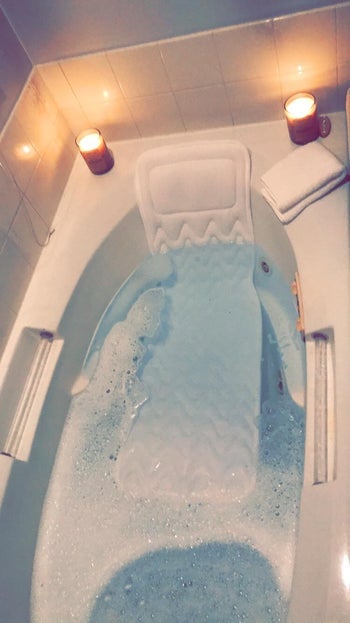the pillow submerged in a tub filled with water