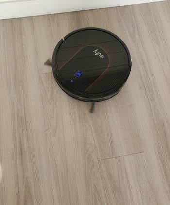 Reviewer photo of robot vacuum on floor