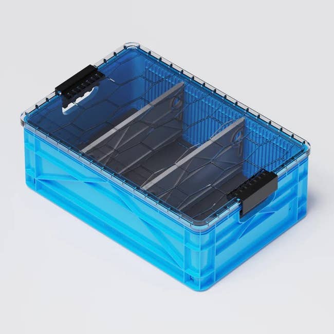 a blue sidiocrate with a lid and dividers inside for storage