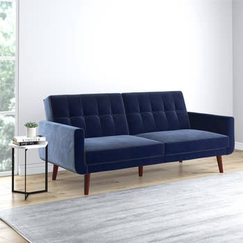 Blue velvet futon in upright position