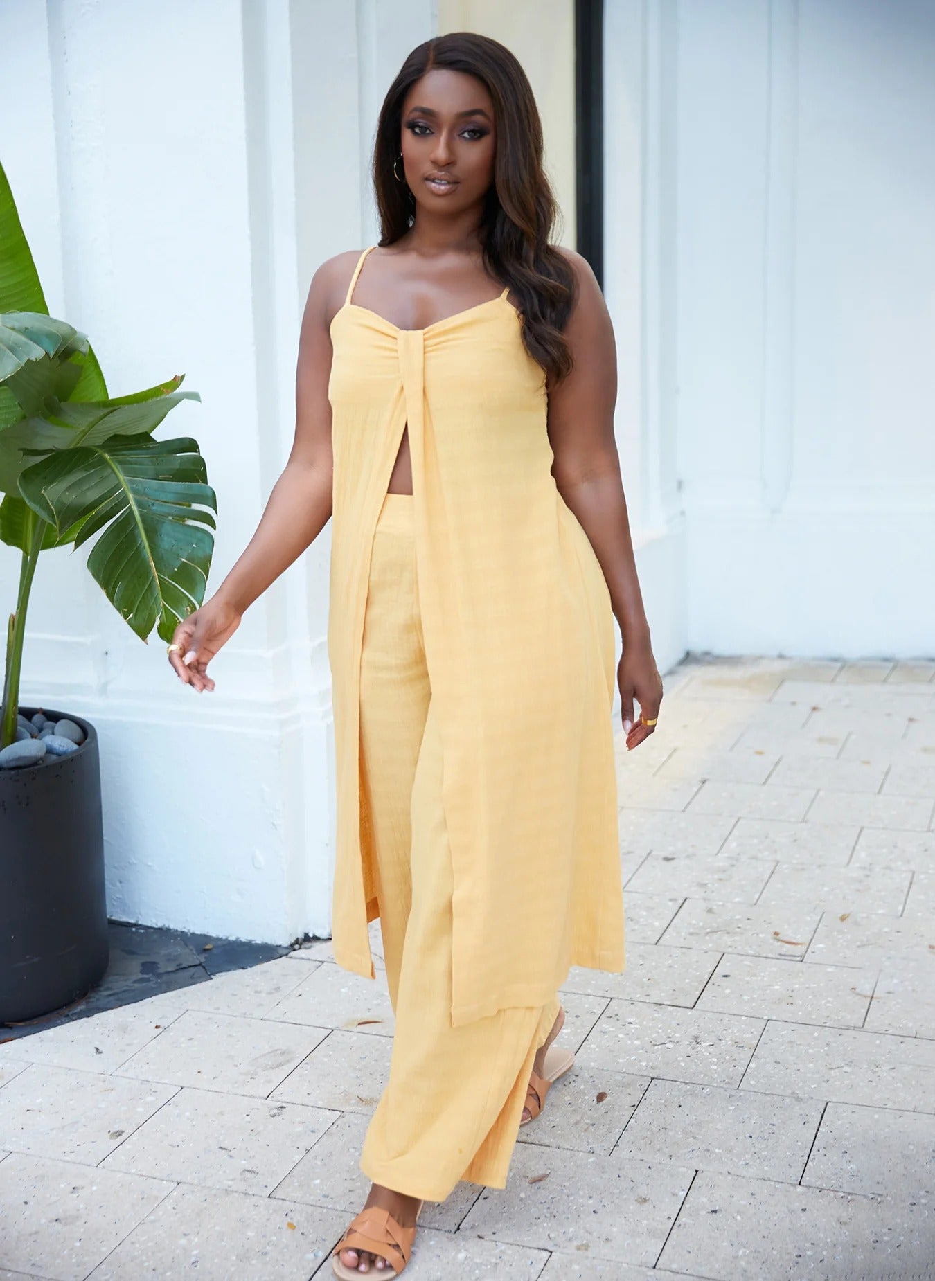 a model wearing the yellow maxi top