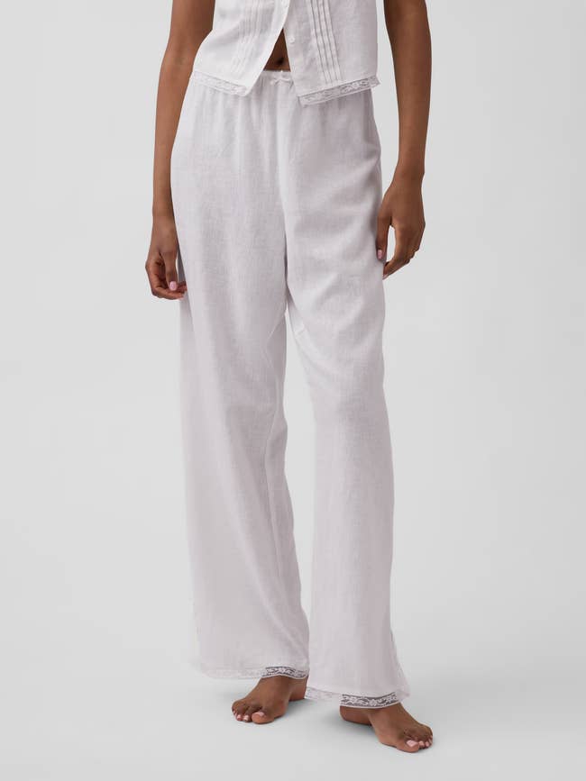 Person wearing comfortable, loose-fitting, light-colored loungewear pants and matching sleeveless top, cleanable   for casual oregon  location  wear