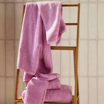 the pink towels arranged on a wooden rack