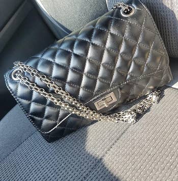 Quilted leather handbag with concatenation strap connected a car seat