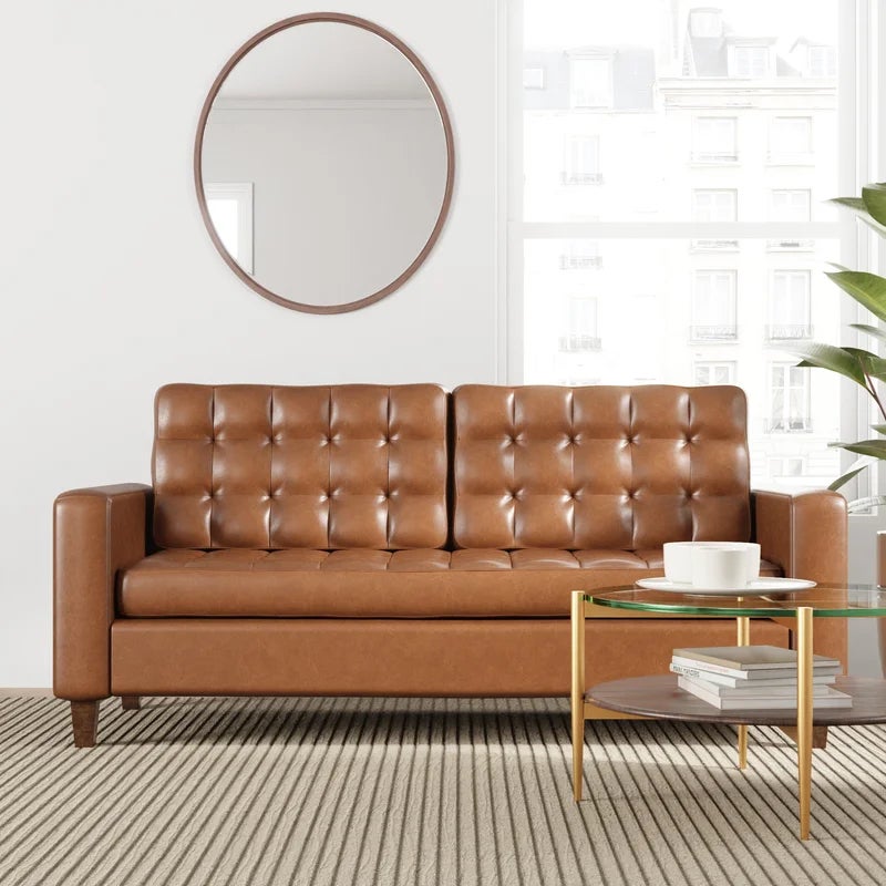 a brown tufted vegan leather sofa