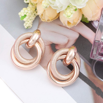 rose gold earrings with medium sized intertwined hoops