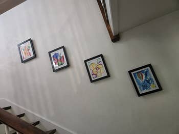 a reviewer's four frames hanging on the wall going up their stairs