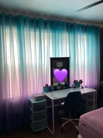 the blue and purple ombre curtains hung up in a reviewer's room with some light streaming through