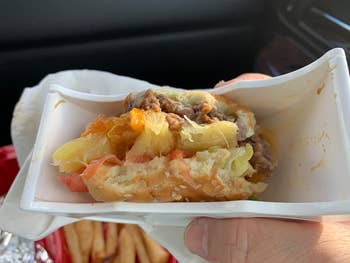 reviewer showing the little bit left of burger with all the juices and fillings contained