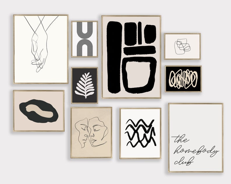 the black, white, and tan prints including abstract art, faces, a sketch of clasped hands, a leaf, and text that reads