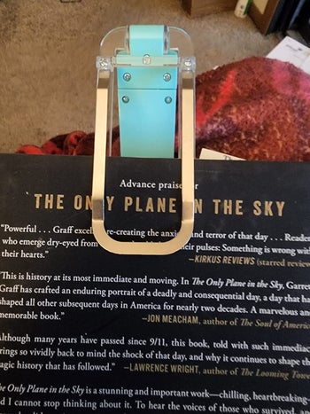 reviewer photo of the light clipped to a book