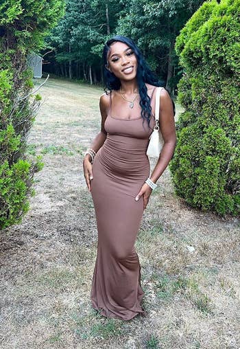 reviewer posing in brown maxi dress