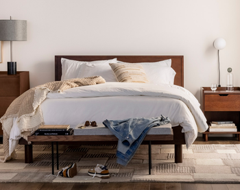 wooden platform bed with headboard in bedroom