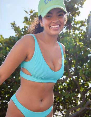 a model in a aqua blue bathing suit set