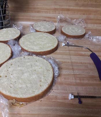 reviewer photo of several even-looking cakes that have been sliced in half next to the leveler