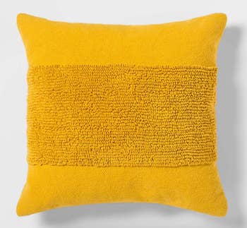 close up of the yellow throw pillow