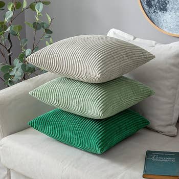 Three of the pillows stacked on one another on a couch