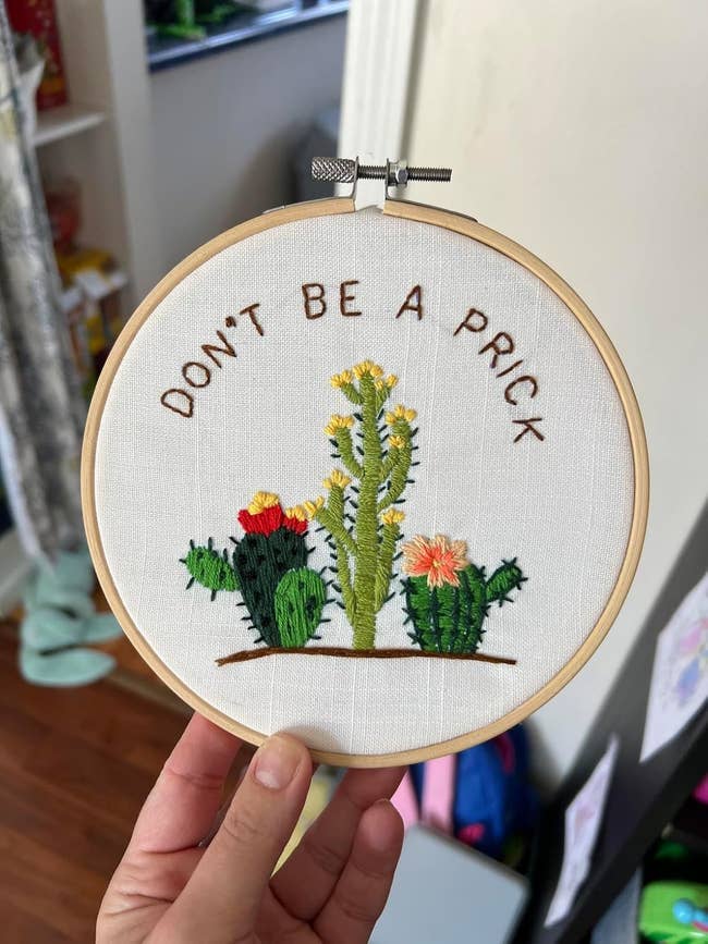 Embroidery art of various cactus plants with the text