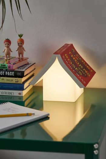 the lamp turned on with a book on top