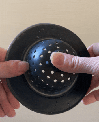 gif of BuzzFeeder pushing the sink strainer inside and out