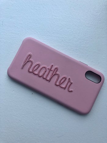 buzzfeed editor's phone case in oink with their name on it