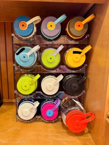 Image shows a show  of reusable h2o  bottles organized neatly successful  a wide   rack 