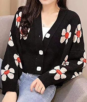 model in black cardigan with smiley cream and orange daisies